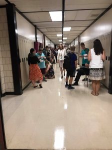 Students and faculty in hallway