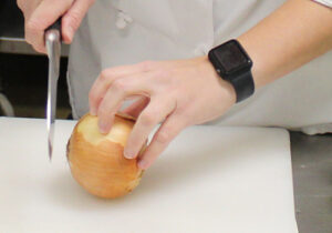 Photo of student chopping an onion